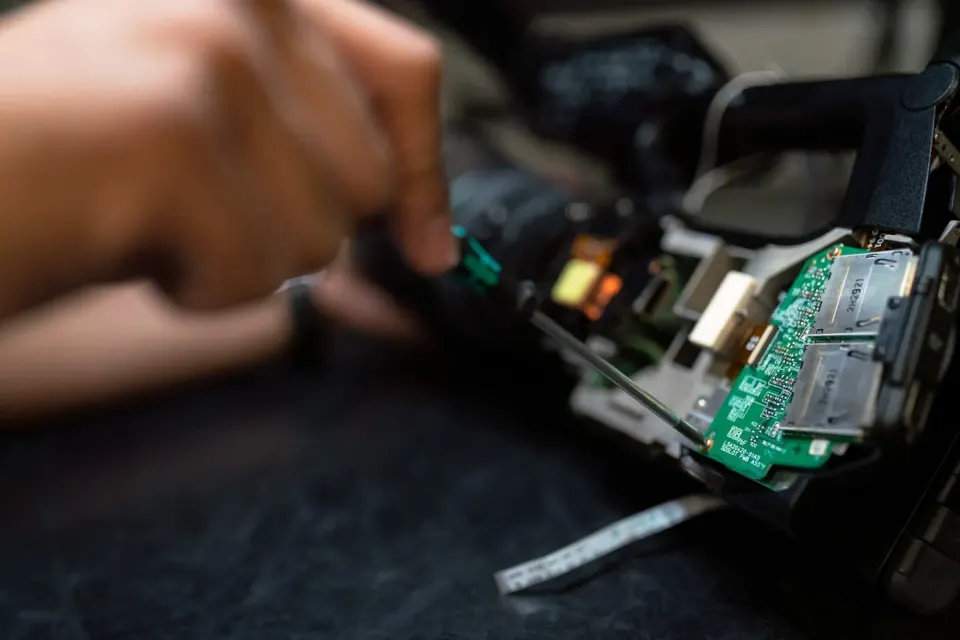 A HackTech engineer working on a locally-made circuit board at the bench